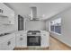 Modern kitchen with stainless steel appliances, and white cabinetry at 4769 Via Renaldo, Las Vegas, NV 89103