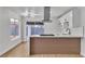 Modern kitchen featuring white cabinets and a stainless-steel hood at 4769 Via Renaldo, Las Vegas, NV 89103