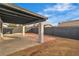 Covered patio featuring white support columns, a black roof, and a red brick extension at 4769 Via Renaldo, Las Vegas, NV 89103