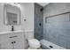 Modern bathroom features gray tiled shower, updated vanity, and contemporary fixtures at 4825 Randall Dr, Las Vegas, NV 89122