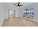 A bright living room with light wood floors and a view of a palm tree at 4825 Randall Dr, Las Vegas, NV 89122