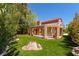 Manicured backyard with lush lawn and covered patio area at 5101 Breakers Ln, Las Vegas, NV 89113