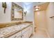 Bathroom featuring marble countertop, ornate mirror, and decorative lighting fixture at 5101 Breakers Ln, Las Vegas, NV 89113