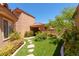 Charming home exterior with lush greenery and inviting walkway at 5101 Breakers Ln, Las Vegas, NV 89113