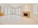 Living room with fireplace, tile floors, and several windows offering natural light at 5101 Breakers Ln, Las Vegas, NV 89113