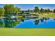 Picturesque pond on the golf course with green, trees, waterfall, and flag at 5101 Breakers Ln, Las Vegas, NV 89113