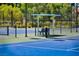 A well-maintained tennis court features green and blue surface and seating for spectators at 5101 Breakers Ln, Las Vegas, NV 89113