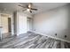 Bedroom with wood-look floors, ceiling fan, and ample closet space at 5326 Swenson St # 61, Las Vegas, NV 89119