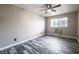 Comfortable bedroom with wood-look floors, a ceiling fan, and a bright window at 5326 Swenson St # 61, Las Vegas, NV 89119