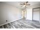 Spacious bedroom featuring wood-look flooring, ceiling fan, and convenient closet at 5326 Swenson St # 61, Las Vegas, NV 89119