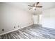 Well-lit bedroom featuring wood-look floors, ceiling fan, and closet at 5326 Swenson St # 61, Las Vegas, NV 89119