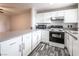 Modern kitchen featuring white cabinetry, stainless steel appliances, and sleek countertops at 5326 Swenson St # 61, Las Vegas, NV 89119