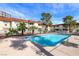 Community swimming pool with surrounding apartment buildings under blue sky at 5326 Swenson St # 61, Las Vegas, NV 89119