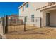 Gated backyard featuring a low-maintenance desert landscape and access to the home's entrance at 5357 Hammond Ct, Las Vegas, NV 89110