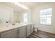 Updated bathroom with gray vanity, large mirror, and modern lighting at 5357 Hammond Ct, Las Vegas, NV 89110