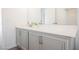 Bathroom features a gray vanity with double sinks and a large mirror at 5357 Hammond Ct, Las Vegas, NV 89110