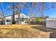 Large backyard with a patio area, mature trees, a balcony, and a storage shed at 5825 Bent Branch Ln, Las Vegas, NV 89142