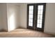 Bedroom with double doors leading outside, featuring neutral walls and plush carpeting at 5825 Bent Branch Ln, Las Vegas, NV 89142