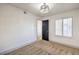 Bright bedroom features neutral carpet, a modern ceiling light fixture, and a window with wood shutters at 5825 Bent Branch Ln, Las Vegas, NV 89142