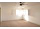 Sunlit bedroom featuring plush carpeting, neutral walls, and window shutters at 5825 Bent Branch Ln, Las Vegas, NV 89142