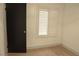 Bright bedroom with tan carpet, white walls, and modern window shutters at 5825 Bent Branch Ln, Las Vegas, NV 89142