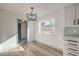 Dining area with natural light, modern light fixture, and wood flooring at 5825 Bent Branch Ln, Las Vegas, NV 89142