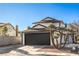 Inviting two-story home with a well-kept yard and a spacious driveway leading to a two-car garage on a clear day at 5825 Bent Branch Ln, Las Vegas, NV 89142