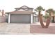 Charming two-story home featuring a well-maintained lawn and two-car garage at 5825 Bent Branch Ln, Las Vegas, NV 89142