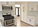 Modern kitchen with stainless steel appliances and a stylish lighting fixture at 5825 Bent Branch Ln, Las Vegas, NV 89142