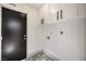 Convenient laundry room featuring ample storage cabinets and stylish patterned flooring at 5825 Bent Branch Ln, Las Vegas, NV 89142