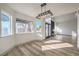 Open concept living room with wood flooring, large windows, and light gray trim at 5825 Bent Branch Ln, Las Vegas, NV 89142