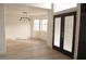 Bright living room featuring wood floors, ample windows, and stylish light fixture at 5825 Bent Branch Ln, Las Vegas, NV 89142