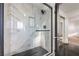 Beautiful shower featuring modern fixtures, a glass door, and updated marble-patterned wall tile at 5825 Bent Branch Ln, Las Vegas, NV 89142