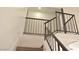 Staircase featuring a black metal railing and carpeted steps, leading to the upper level at 5825 Bent Branch Ln, Las Vegas, NV 89142