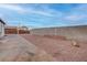 Large backyard featuring rock landscaping and concrete, fully enclosed for privacy and low upkeep at 613 W Victory Rd, Henderson, NV 89015