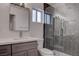 Modern bathroom features a herringbone-tiled shower and a vanity with a sleek, minimalist design at 613 W Victory Rd, Henderson, NV 89015