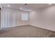 Spacious bedroom with carpet, white walls, recessed lighting and sliding glass doors at 613 W Victory Rd, Henderson, NV 89015