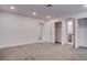 A bright bedroom with ensuite bathroom and closet is carpeted in neutral grey tones at 613 W Victory Rd, Henderson, NV 89015