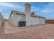 Back exterior view of home with a small patio and gravel landscaping at 613 W Victory Rd, Henderson, NV 89015