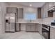 Spacious kitchen with stainless steel appliances, light countertops, and gray cabinets at 613 W Victory Rd, Henderson, NV 89015