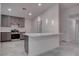 Kitchen features bar, gray cabinets, stainless steel oven, and recessed lighting at 613 W Victory Rd, Henderson, NV 89015