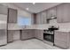 Modern kitchen featuring stainless steel appliances and stylish grey cabinets at 613 W Victory Rd, Henderson, NV 89015