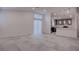 Open-concept living area with tile flooring flows into kitchen with bar and modern pendant lighting at 613 W Victory Rd, Henderson, NV 89015