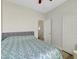 Well-lit bedroom featuring a bed with geometric patterned comforter, neutral headboard and floors, and a closet for storage at 6320 Desert Leaf St # 101, North Las Vegas, NV 89081