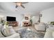 Well-lit living space featuring an open floor plan, neutral tones, and wood-style flooring at 6320 Desert Leaf St # 101, North Las Vegas, NV 89081