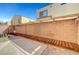 Backyard patio area featuring decorative brick pavers and block wall for privacy at 6320 Desert Leaf St # 101, North Las Vegas, NV 89081