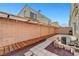 Backyard patio area featuring decorative rock, wood elements, and block wall for privacy at 6320 Desert Leaf St # 101, North Las Vegas, NV 89081