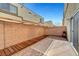 Private patio area with block wall, partial awning, and easy-care landscaping at 6320 Desert Leaf St # 101, North Las Vegas, NV 89081