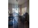 Bright dining area with a sliding glass door and a chandelier above the wooden table at 6380 Extreme Shear Ave # 102, Henderson, NV 89011