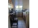 Functional kitchen featuring wooden cabinetry, tile flooring, and appliances at 6380 Extreme Shear Ave # 102, Henderson, NV 89011